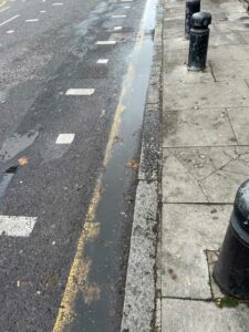 Photograph of a highway and rainwater puddle