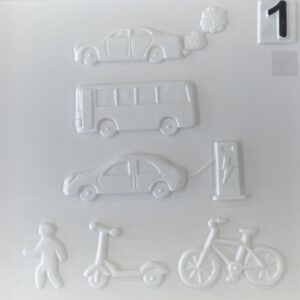 Page from a 3-d book for blind and visually impaired children. The page shows a saloon car emitting clouds of exhaust fumes; a bus; a saloon car connected to an electric vehicle charging point by a lead; a person walking; a scooter; a traditional bicycle. The images are shown side-on. The page is all white.