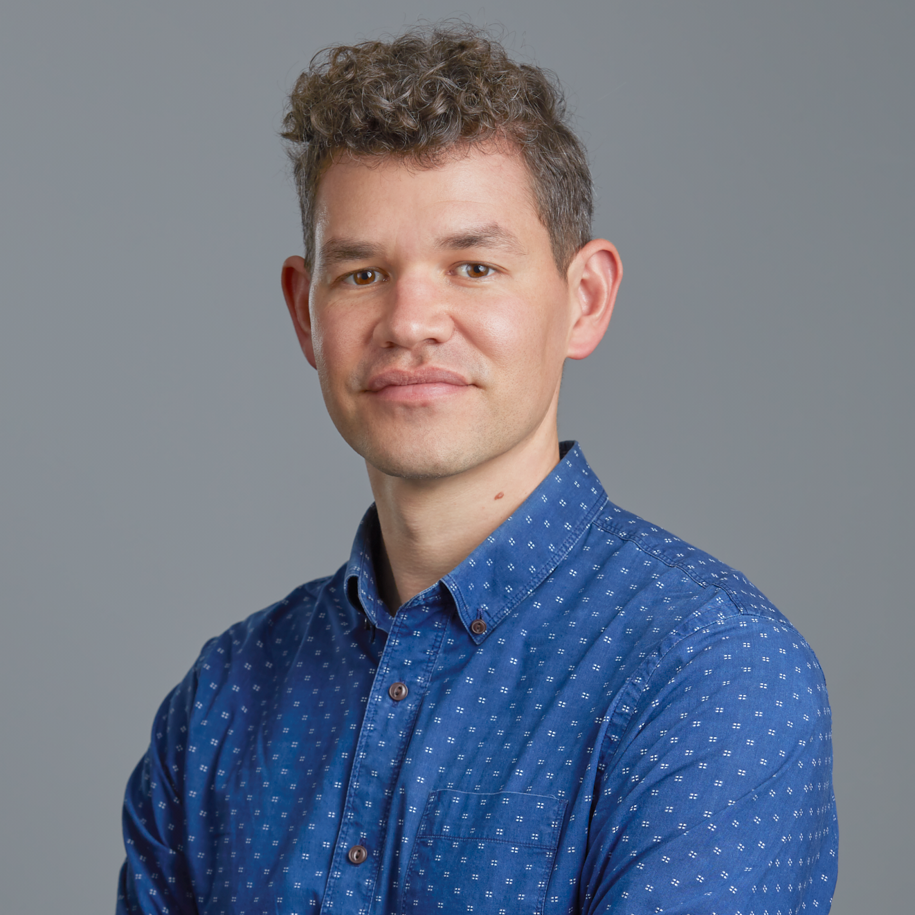 Head and shoulder photograph of a person wearing a blue shirt.