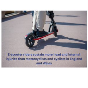 Image of the lower half of an electric scooter showing the feet and lower legs of someone riding it over a hard road surface